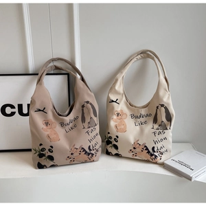 Close-up of canvas tote bags with cute animal prints and durable double shoulder straps