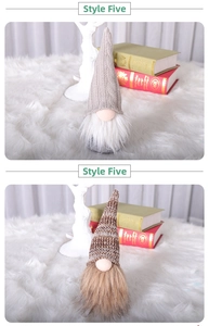 Vertical detail of two handmade knit Christmas gnomes with long beards and cozy plush decor