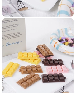 Detail showing colorful resin chocolate charms with hanging holes for DIY crafts