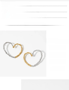 Detail showing textured PVD gold and silver finish on heart earrings in macro view