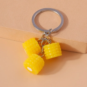 Detailed view of yellow resin corn cob charms on a durable metal circular keychain