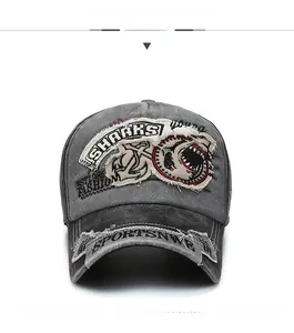 Detailed front view of vintage washed cotton baseball cap with shark embroidery and distressed finish