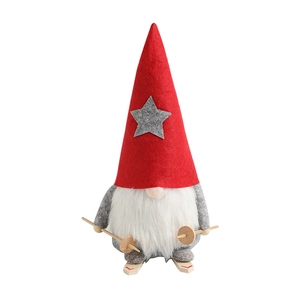 Standing Christmas gnome with red hat and ski poles on a clean white background
