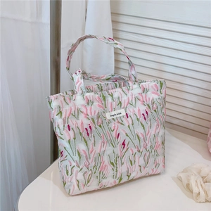Detail of pink tulip jacquard fabric tote bag with a simple wish woven label
