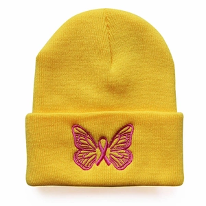 Bright yellow knit beanie featuring pink butterfly embroidery and a warm ribbed texture