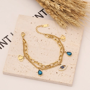 Double-layered gold stainless steel necklace set with evil eye and blue teardrop charms