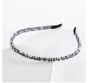 Detail shot of sparkling double-row crystal beads on a sleek gunmetal gray headband