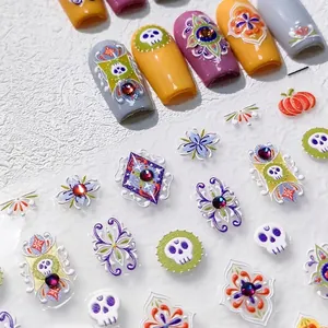 3D Halloween nail stickers with embossed pumpkin and skull designs plus rhinestones
