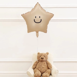 Star-shaped smiley face balloon in beige with a cute teddy bear for party decoration
