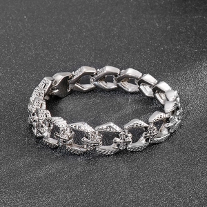 Close-up of vintage punk cross pattern on thick masculine stainless steel link bracelet