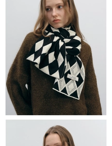 Detail view of woven diamond pattern scarf with original design label and soft texture