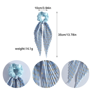 Light blue scrunchie with gold cross pattern and long streamer detailing size and weight