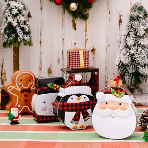 Close-up of four festive Christmas tins featuring gingerbread man, snowman, and Santa shapes