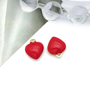 Detail of red enamel heart charms with gold loops for DIY jewelry making sets