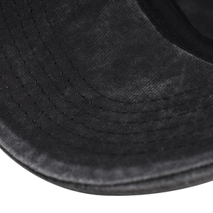 Macro shot of washed cotton baseball cap brim with precise four-row reinforced stitching