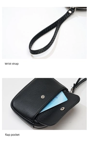 Detail view of black lychee grain leather wallet with wrist strap and front flap pocket