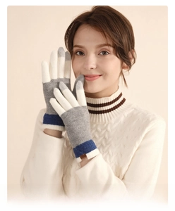 Detail of wool knit gloves featuring touchscreen fingertips and chic striped pattern