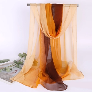 Detail of a thin gradient chiffon scarf transitioning from deep brown to beige on a rack