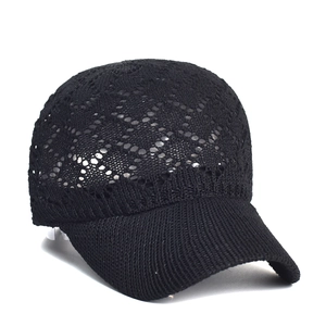 Detail of black lace crochet hollow mesh texture on a breathable summer baseball cap