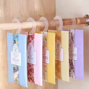 Set of scented wardrobe sachets with hooks in various floral scents hanging on a wooden rod