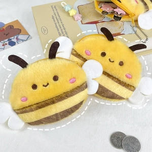 Cute plush bee coin purse with yellow wings and zipper closure on a bright background