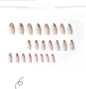 Detail of coral red and mint green geometric press-on nails set with sleek white lines