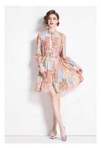 Detail of bohemian floral patchwork print dress with stand collar and button front