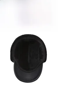 Detail of warm black winter hat featuring thick faux fur lining and windproof leather brim
