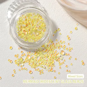 Macro shot of iridescent mermaid aurora glass beads in mixed sizes for nail art decoration
