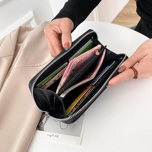 Black embroidered long faux leather wallet featuring multiple card slots and phone pocket