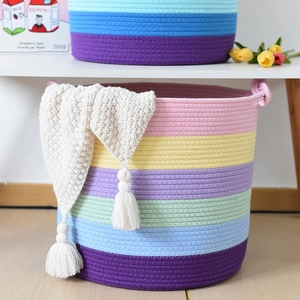 Detail of colorful cotton rope storage basket with rainbow stripes and sturdy handles
