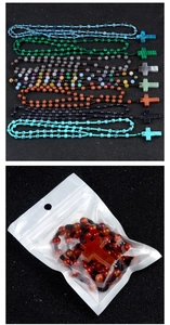 Detail of diverse colorful crystal bead rosary necklaces with a cross pendant