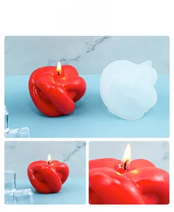Détail macro d'une bougie nœud rouge faite main avec son moule en silicone DIY translucide