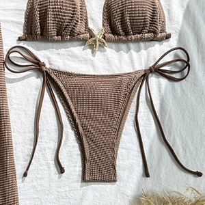 Flat lay of brown textured bikini set with a metal starfish detail on the top