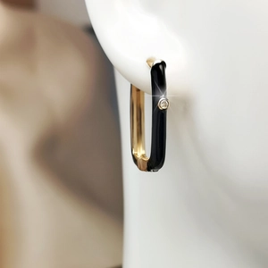Close-up of gold-plated rectangular enamel hoop earrings with a sparkling zircon inlay