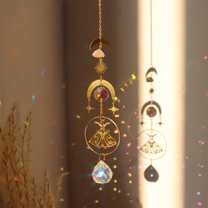 Detailed brass moth suncatcher with pink raw quartz crystal and rainbow light reflections
