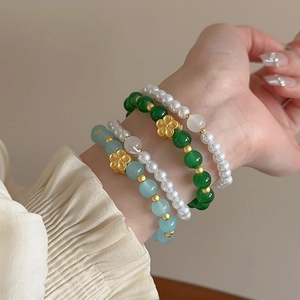 Vintage 2-piece faux pearl beaded bracelet set with colorful glass beads and floral charms