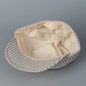 Inside view of grey striped newsboy hat with adjustable drawstring and breathable lining
