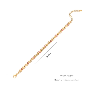 Detail of gold wheat ear bracelet with pink and white enamel on a white background