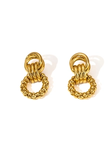 Detail of gold oversized hoop earrings with layered interlocking textured rings for women