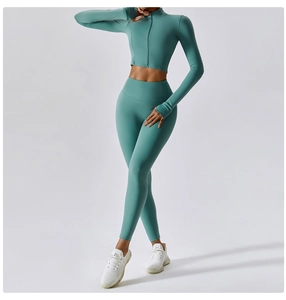 Detail of teal high-waisted yoga leggings and cropped zip-up jacket in seamless knit fabric