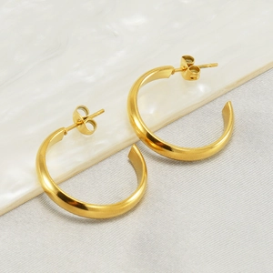 Minimalist gold-plated stainless steel C-shaped hoop earrings on marble surface