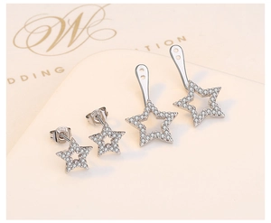 Macro detail of S925 sterling silver star earrings featuring zircon pavé and back-hanging