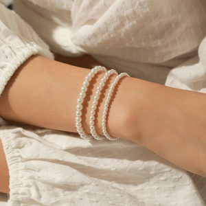 Elegant s925 silver layered pearl bracelet featuring three rows of polished white pearls
