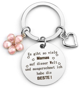 Macro detail of silver keychain with pink flower and German engraving for mothers
