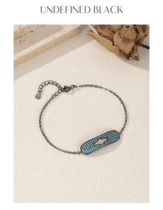 Detail of S925 silver star bracelet with blue stones on a natural beige background
