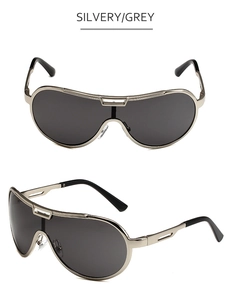 Detail view of silvery metal frame sunglasses with grey lenses and geometric cutouts