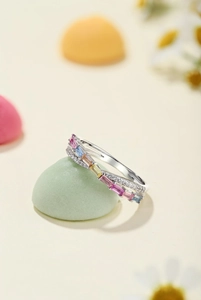 Macro shot of silver ring with colorful rectangular gems and clear zircon details