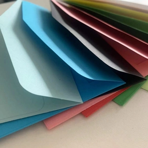 Macro detail of colorful kraft paper envelopes with heart-shaped clasps in various colors