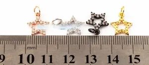 Detailed size view of star pendants with cubic zirconia inlay measuring 10mm wide